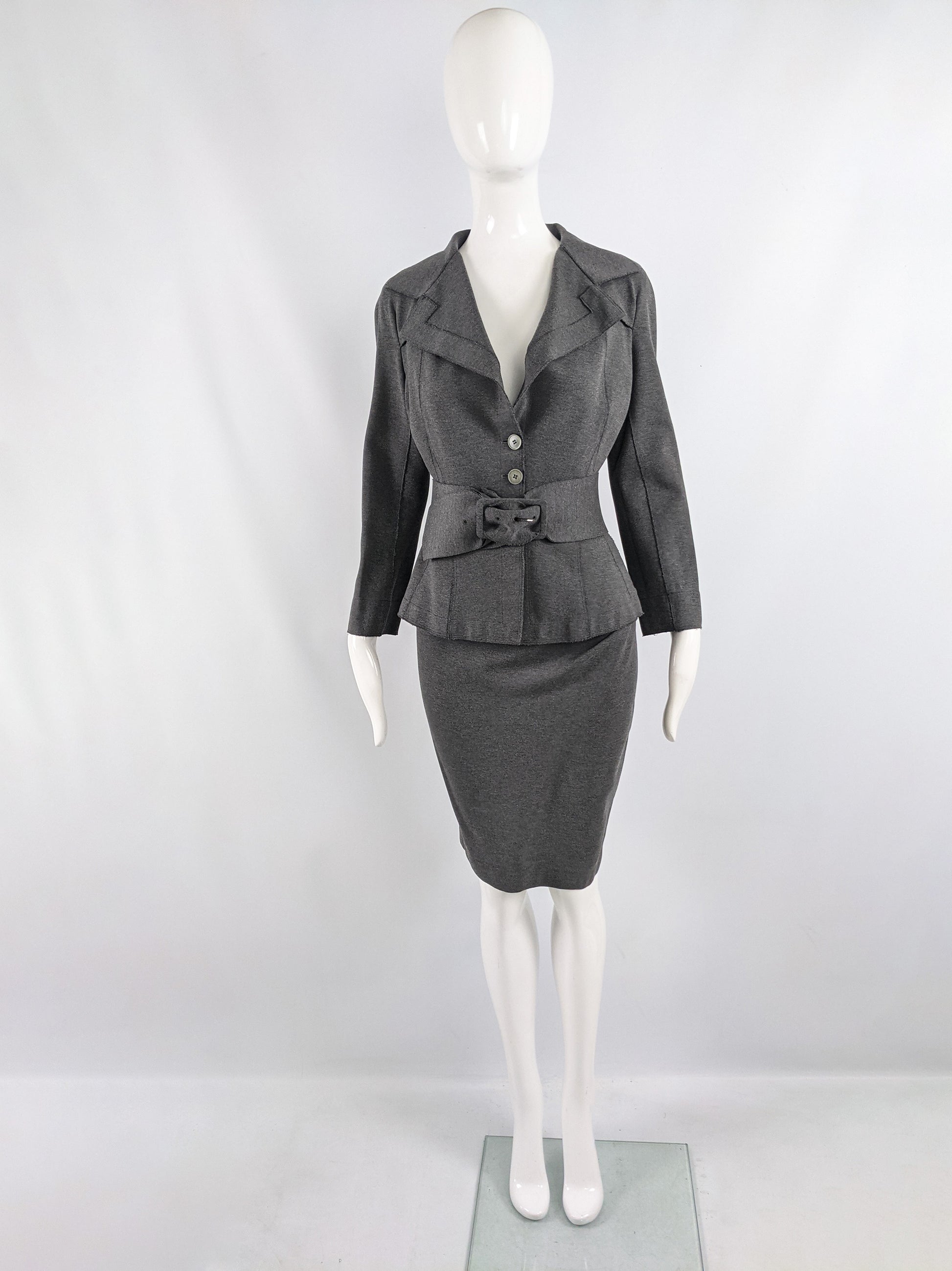 A 1940s style vintage Donna Karan skirt suit in a dark grey stretch knit fabric.