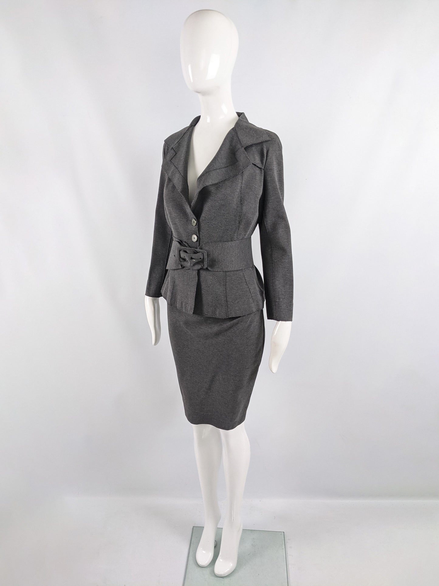 An image of a grey vintage Donna Karan suit for women, consisting of a pencil skirt, blazer and belt.