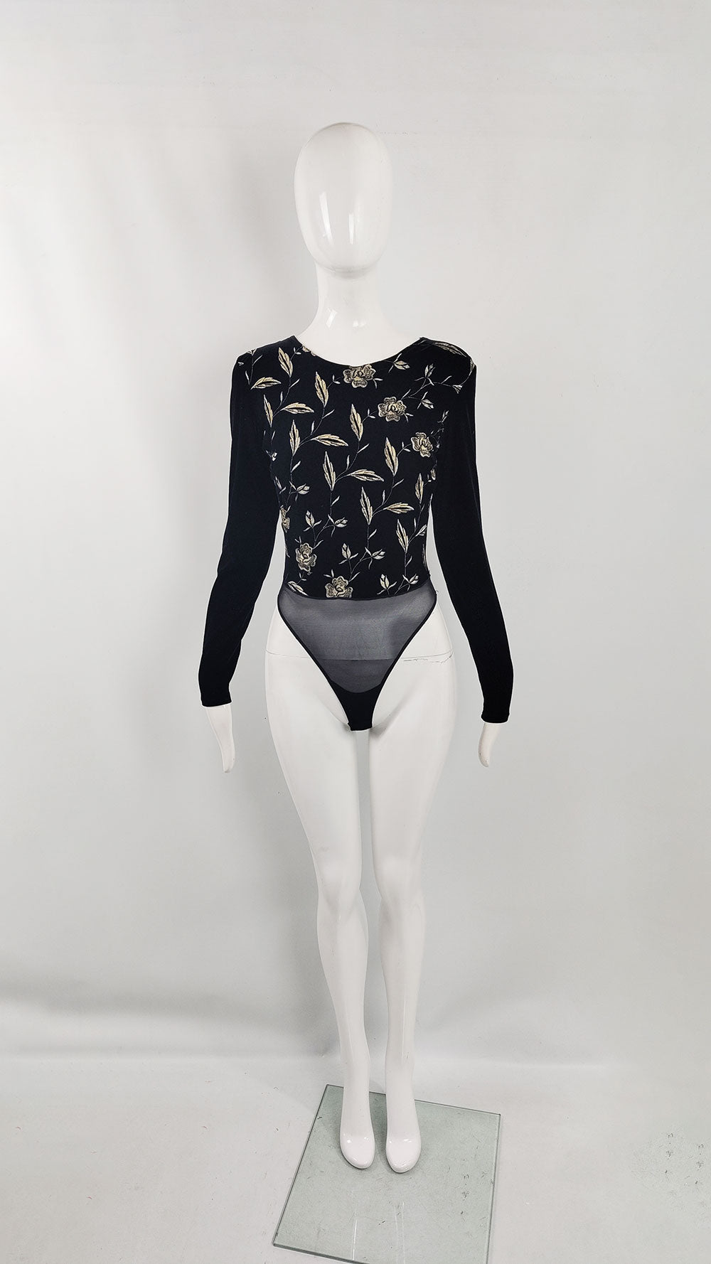 An image of a vintage bodysuit from the 90s by French label, Sagaie. It has long sleeves and an embroidered front - meant for a party.