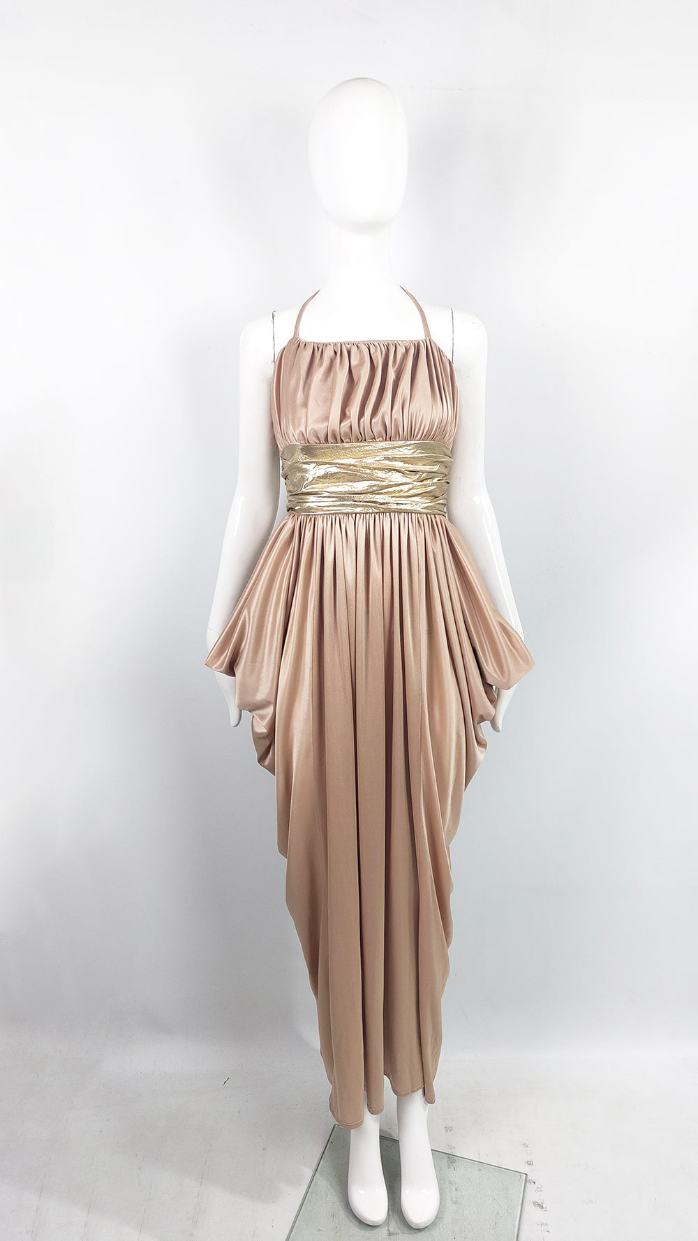 A 1970s evening gown by Ronald Joyce for After Six in a slinky beige and gold jersey.