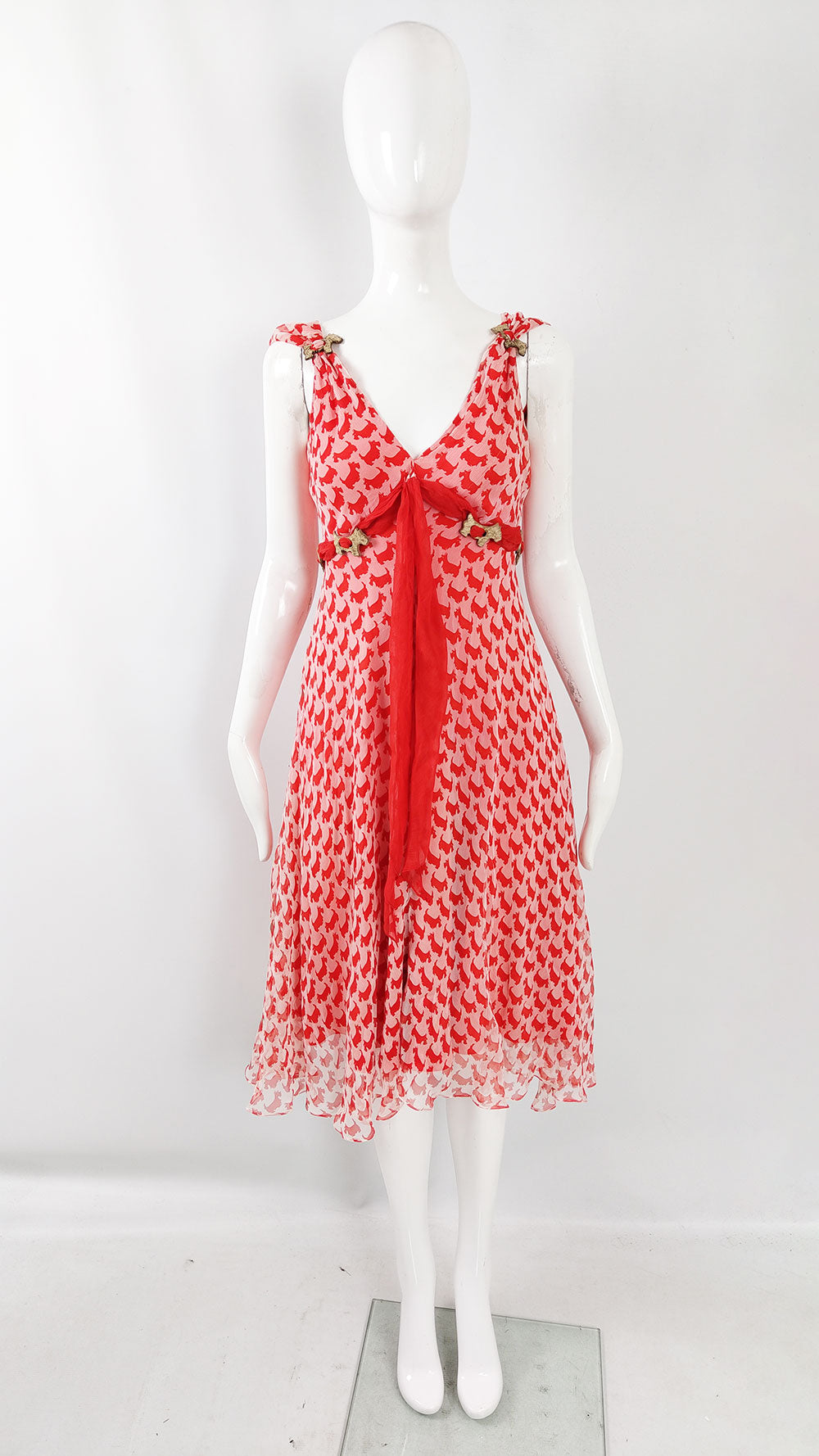 A mannequin wearing a sleeveless vintage Ronit Zilkha dress made from a pink and red silk chiffon with Scottie dogs printed all over.