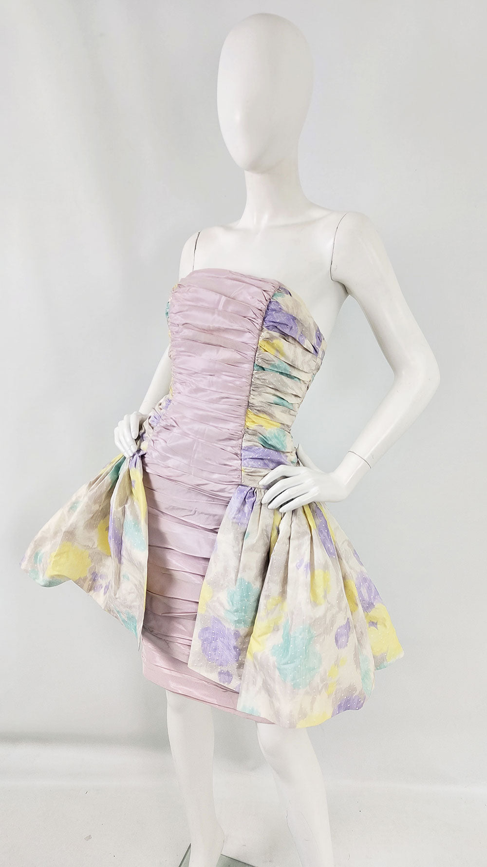 An image of a mannequin wearing a lilac silk floral printed evening dress by Jacques Azagury from the 1980s.
