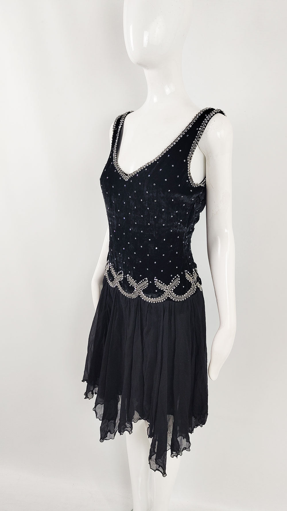 An early 2000s sleeveless vintage party dress  in a black velvet and diaphanous silk chiffon with beading.