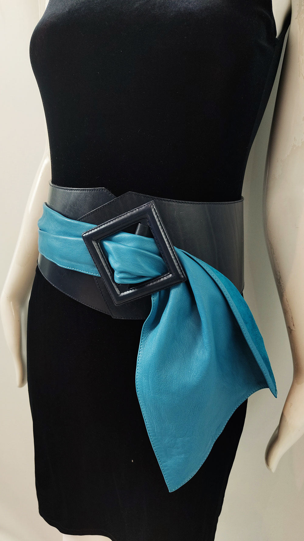 A vintage Byblos belt in a wide belt shape with a large buckle and blue sash detail from the 80s.