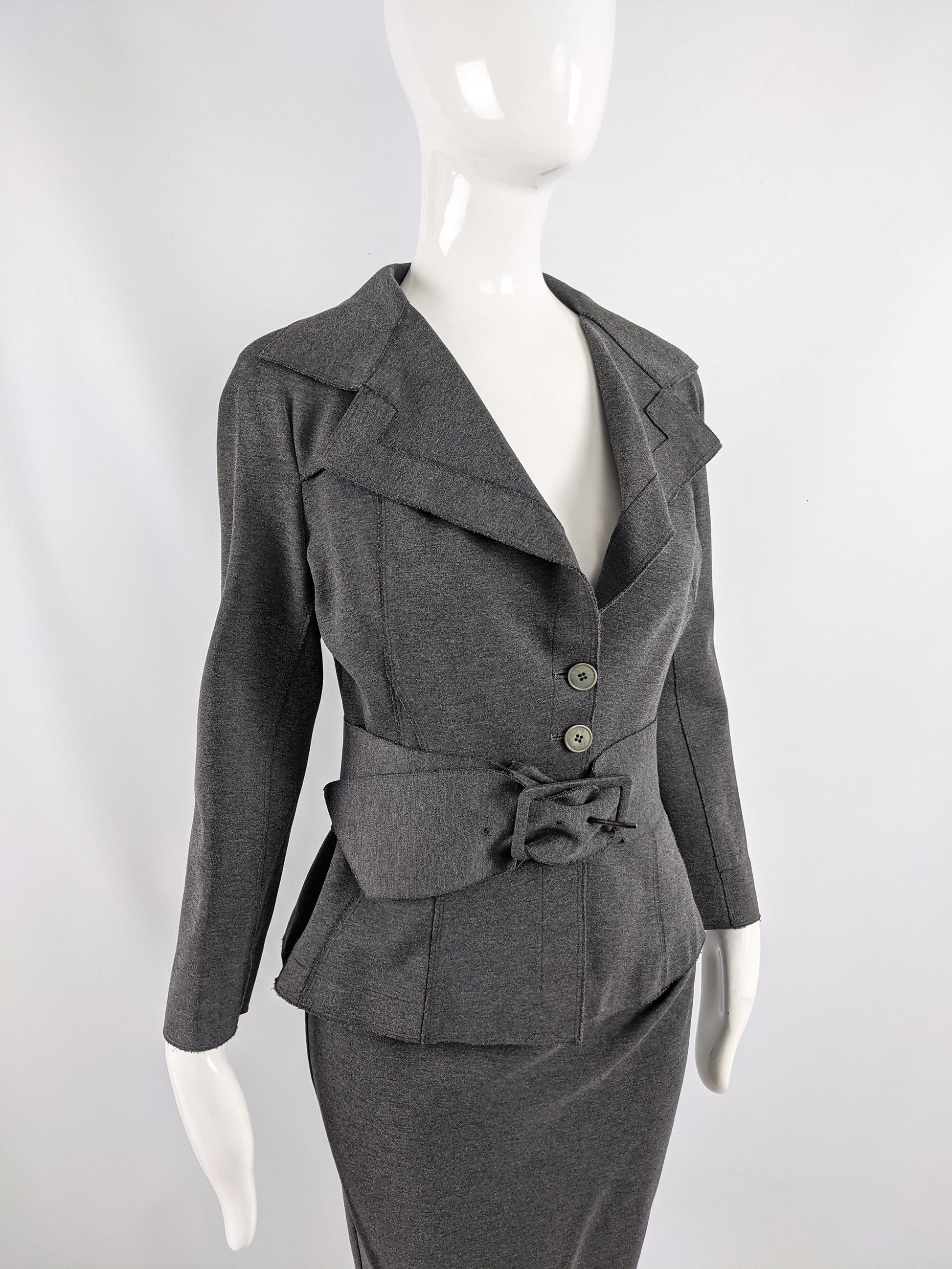 A vintage skirt suit by Donna Karan with a matching blazer, pencil skirt and a wide belt.
