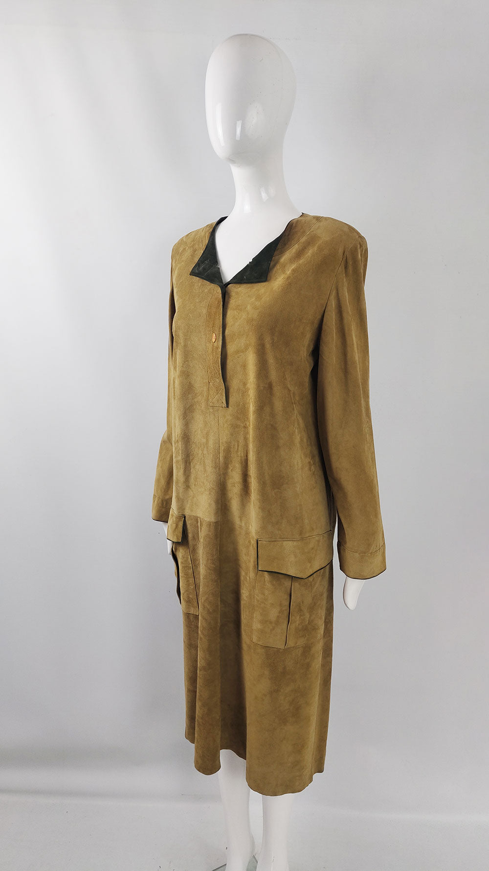 An 80s dress made from a tan and green suede fabric with an oversized fit and shoulder pads by Italian designer, Mario Valentino.