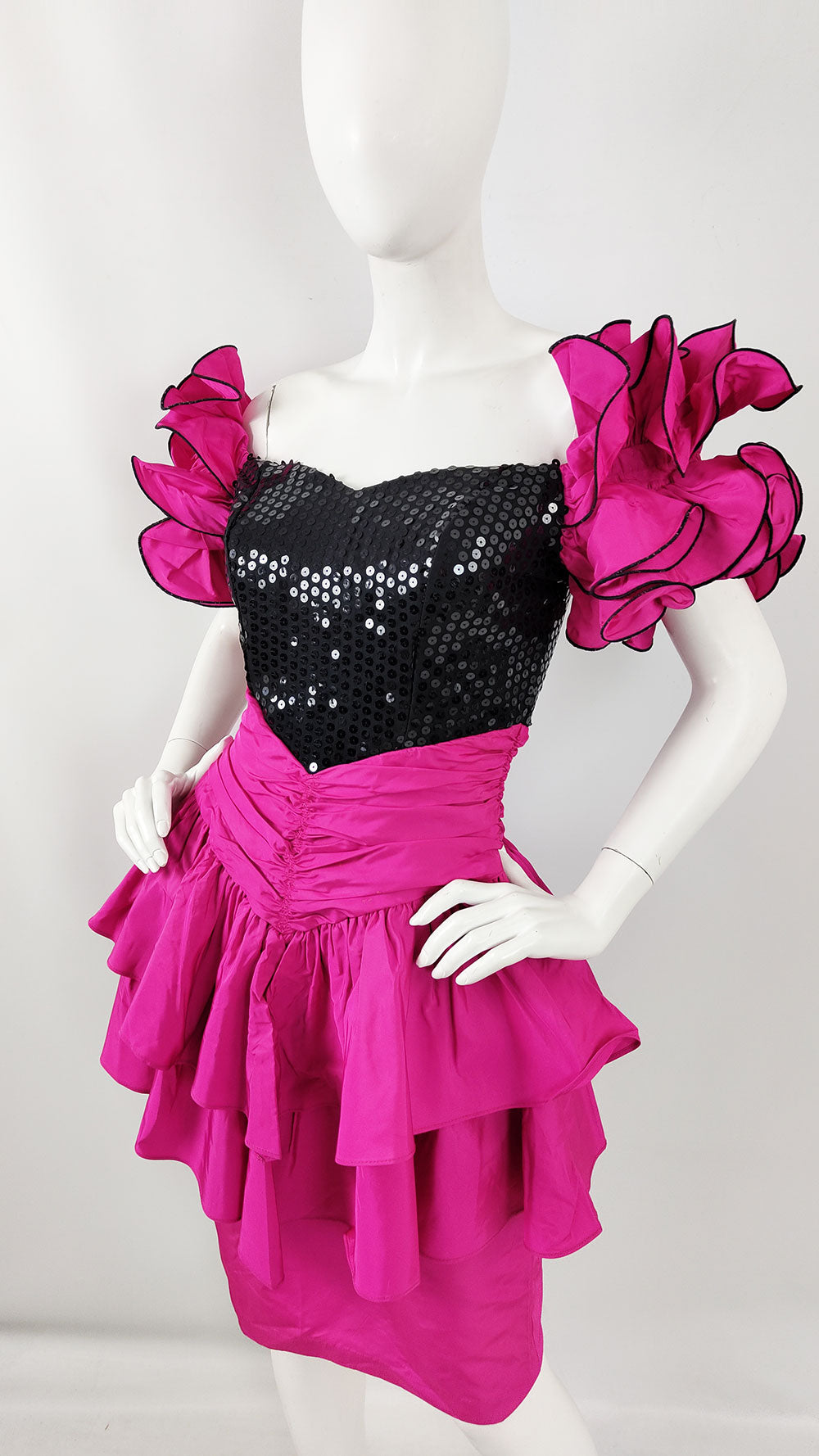 An image of a black and pink taffeta ruffle sleeve prom dress from the 1980s