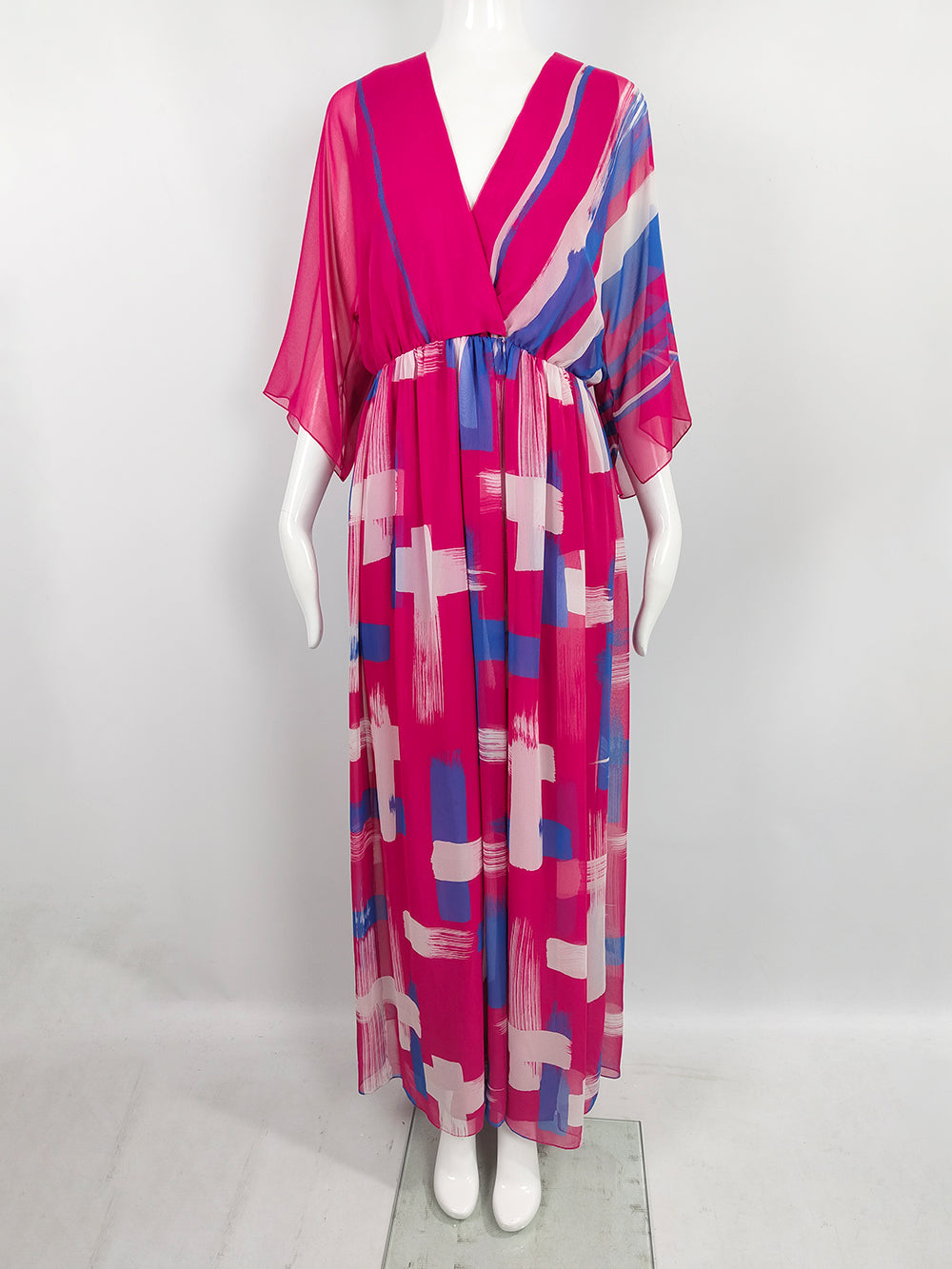 A vintage Hanae Mori pink chiffon maxi dress from the 1970s with a bold print and kimono style sleeves.