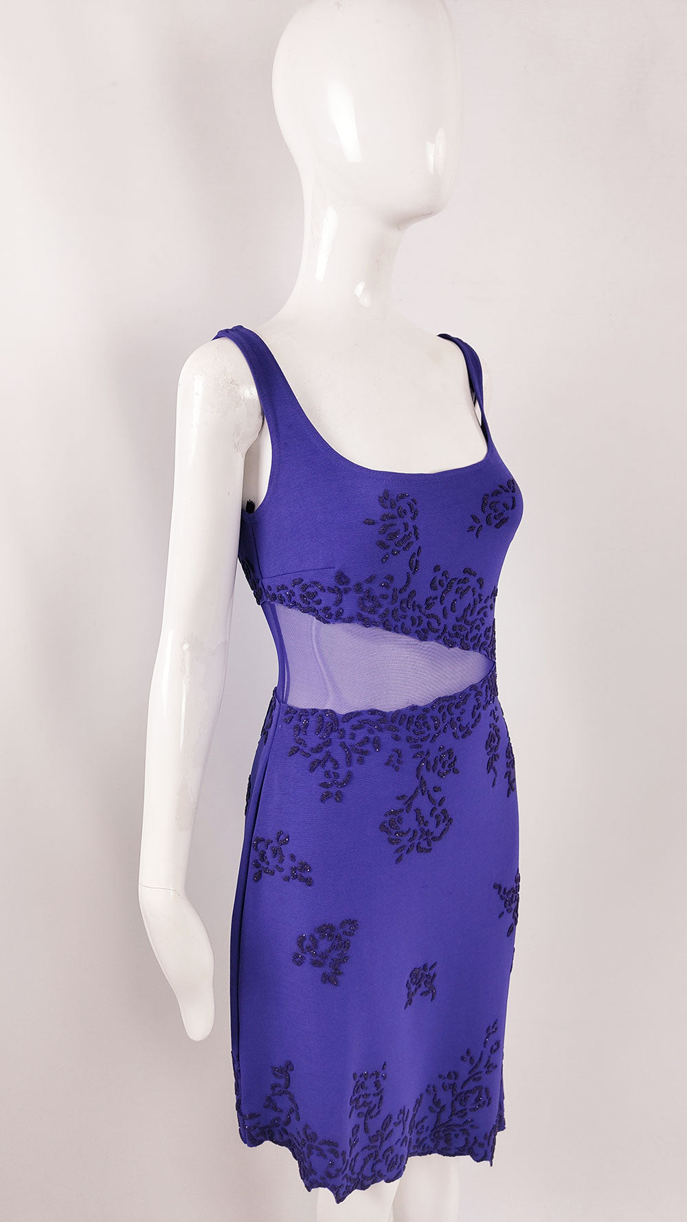 An image of a glamorous vintage beaded evening dress by Tadashi Shoji with a sheer mesh cut out at the front.