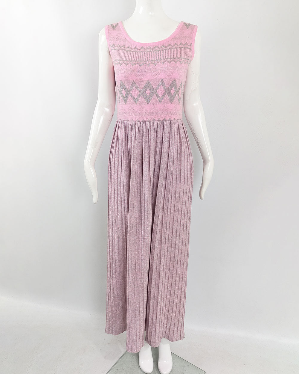 A vintage pink Louis Feraud maxi dress from the 1970s with a pleated skirt and geometric top.