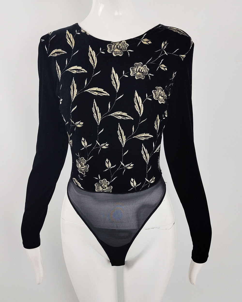 A vintage y2k Sagaie Paris black velour bodysuit with pale cream floral embroidery on the front.