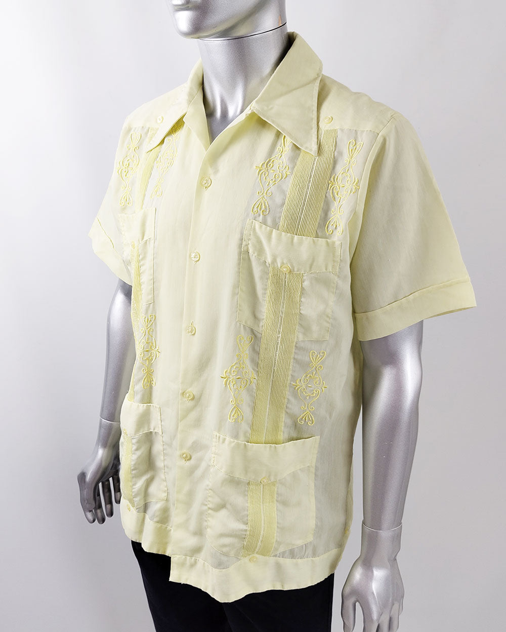 An image of a vintage yellow mexican mens shirt from the 1970s with embroidery and pintuck details. 