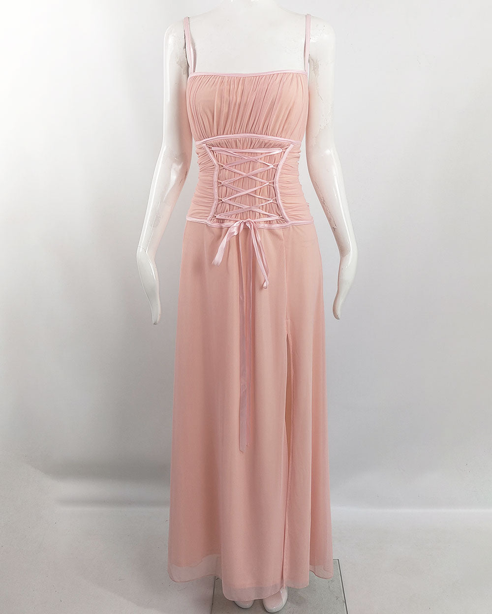 An image of a vintage 1990s tadashi shoji dress in a pink mesh fabric with a corset ribbon detail.