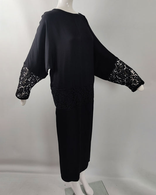 A vintage Gianni Versace dress from the Fall Winter 1985 collection in a black silk with lace details.